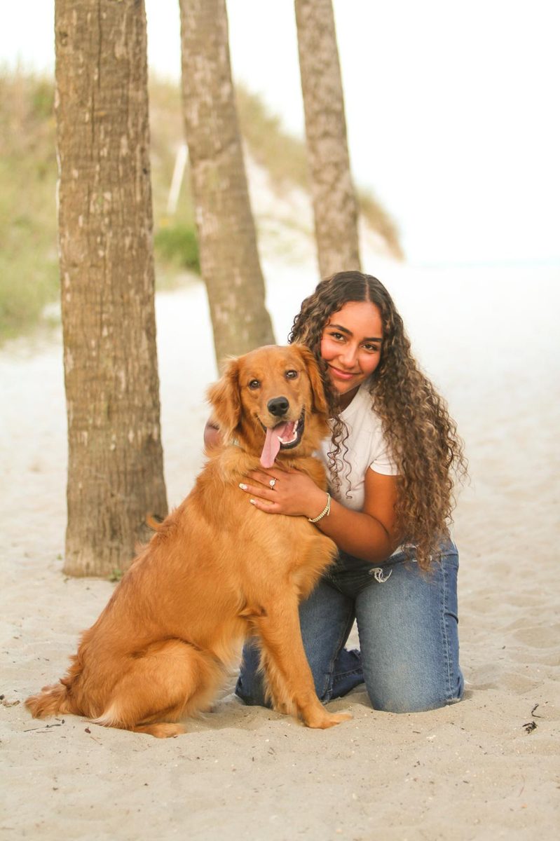 The owners of Elegant Pet Mobile Spa with their golden retriever